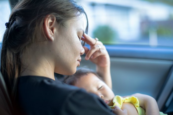 child and mom cuddling in car
