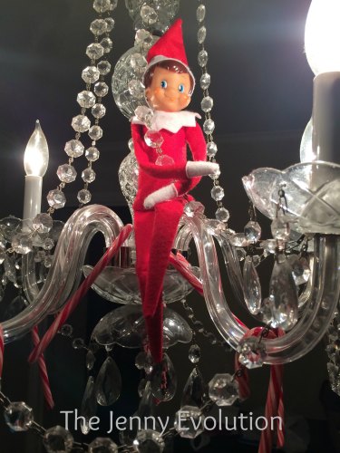 Elf on the Shelf Hanging on out on the Chandelier. He brought candy canes, too! #elfontheshelf #elfideas
