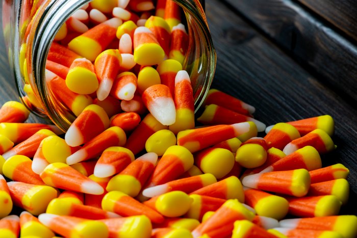 lots of candy corn spilling out of jar