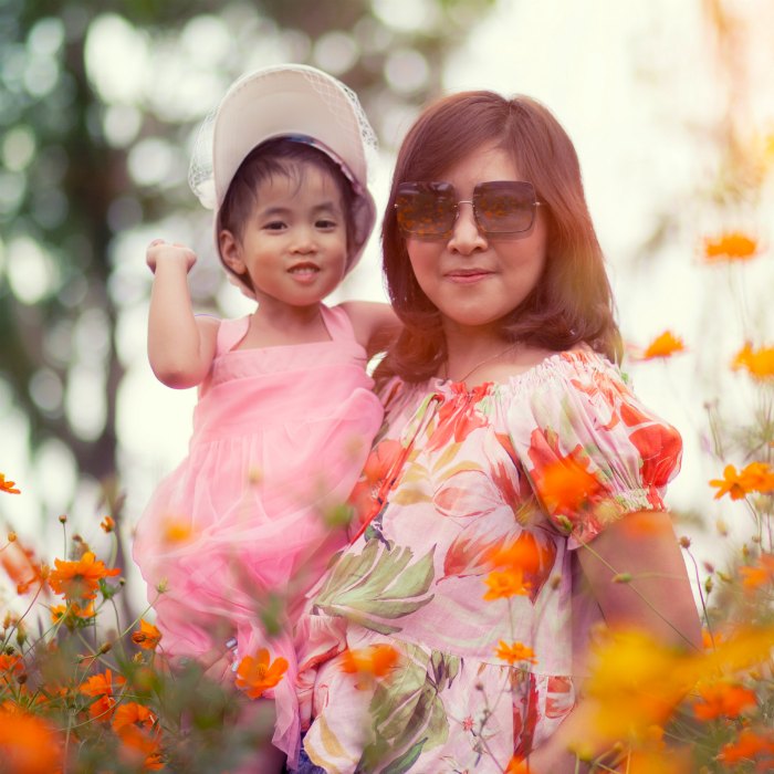 mom and daughter in flower field