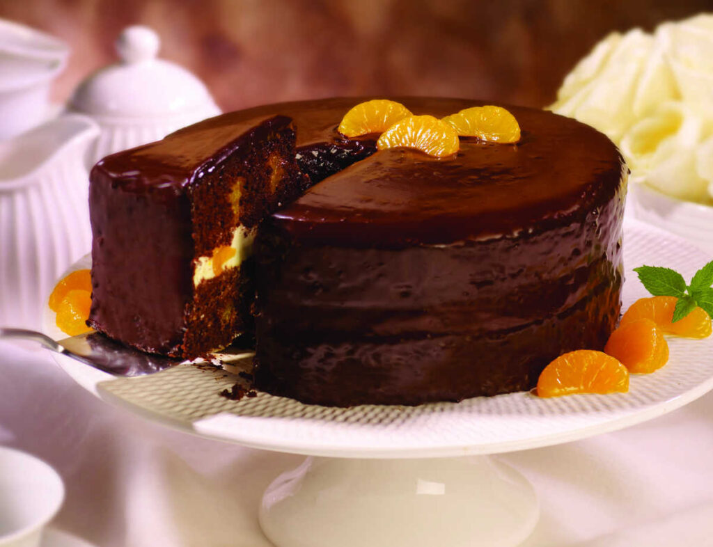 chocolate orange cake on white serving plate