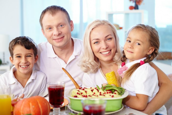 Portrait of happy family having dinner at home