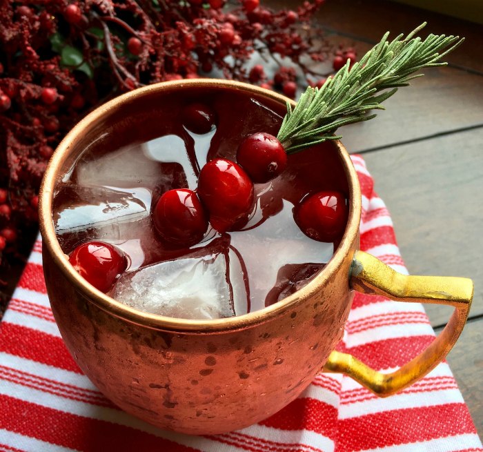 cranberries with sprig in cocktail