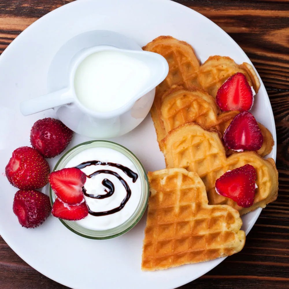 These crisp waffles pair well with sweet toppings and warm drinks that complement their delicate texture while creating a cozy Scandinavian-inspired meal: