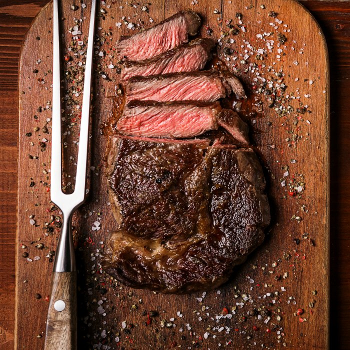 perfectly grilled steak sliced on wooden board