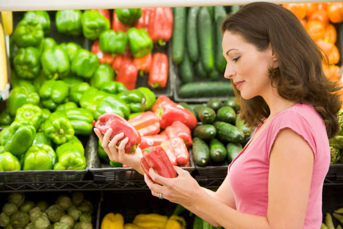 Woman choosing fresh produce in supermarket