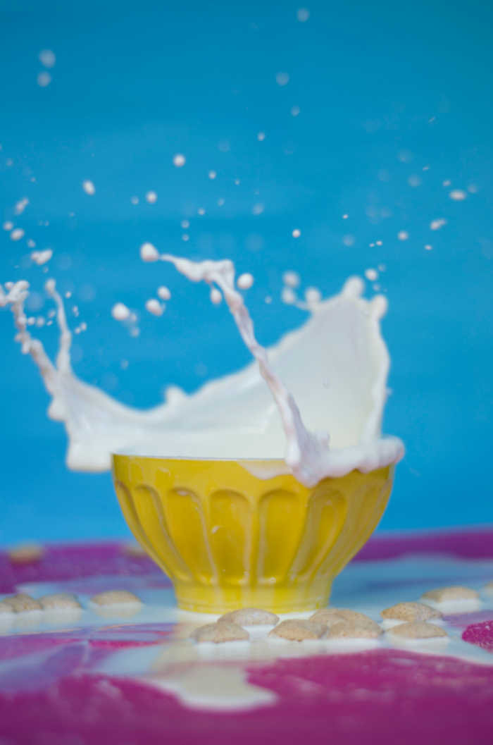 milk dropping into a yellow bowl