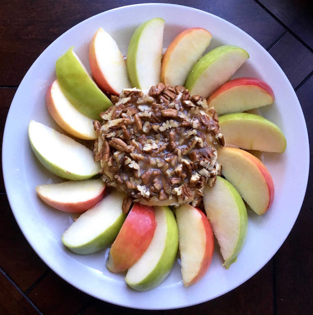 caramel apple dip surrounded by apple slices