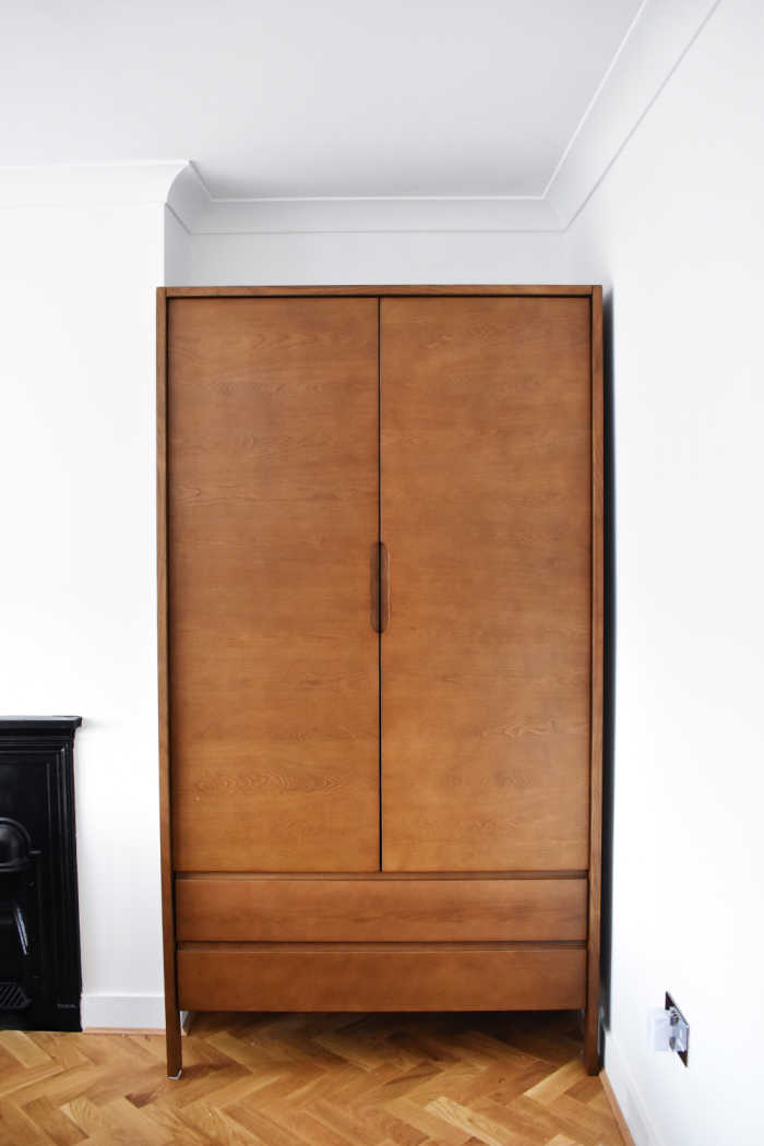 wood armoire in plain room