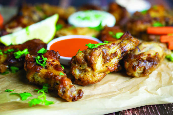 Game Day chicken wings - baked for easy preparation on parchment paper