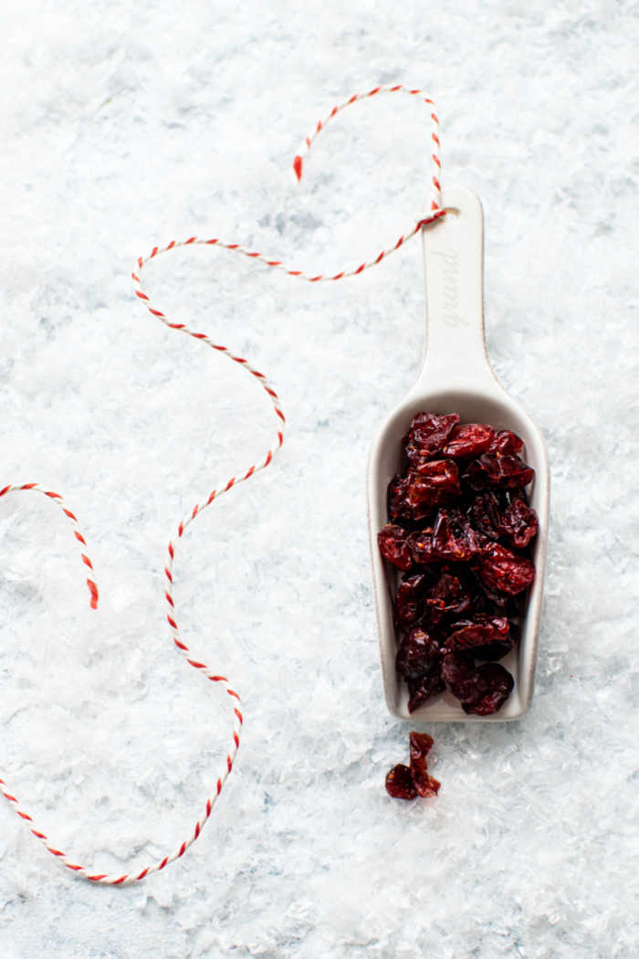 dried cranberries in white scooper