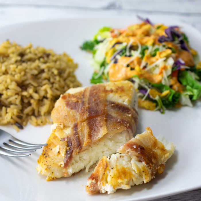 Serve bacon wrapped fish with a salad and rice for the perfect weekday dinner