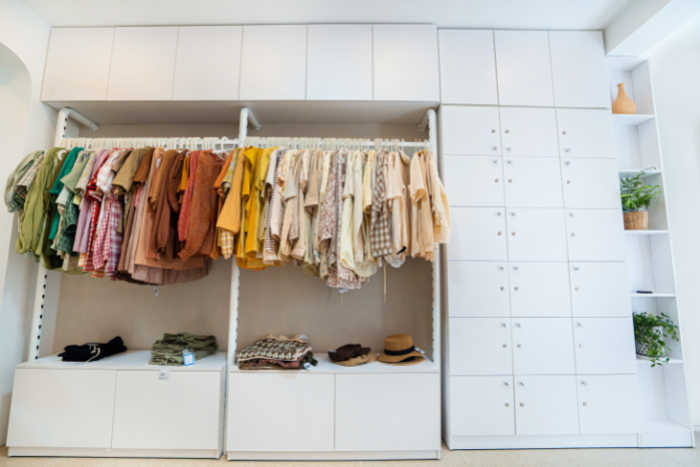 Closet created along full wall of a room with cubbies and places for hangers