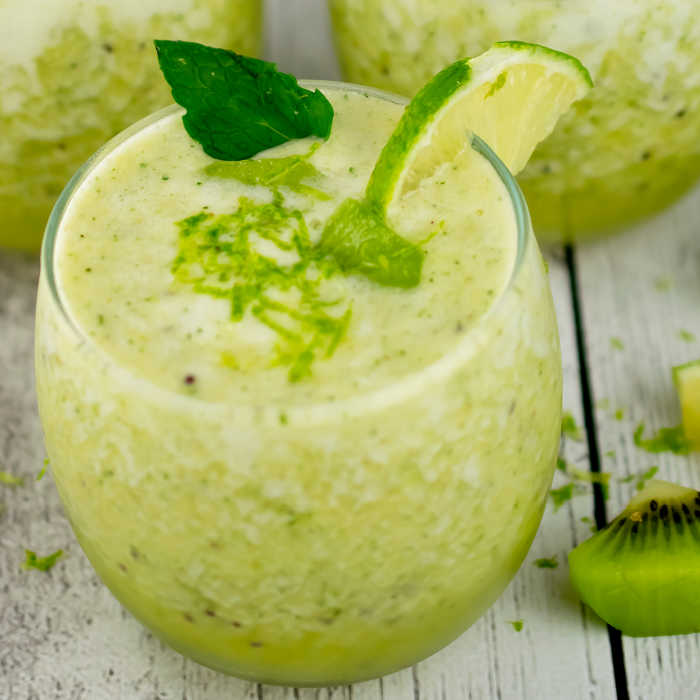 close up lime smoothie in a glass with kiwi slices