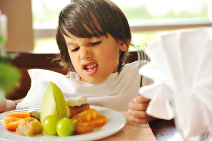 boy fussy eater refusing food on plate