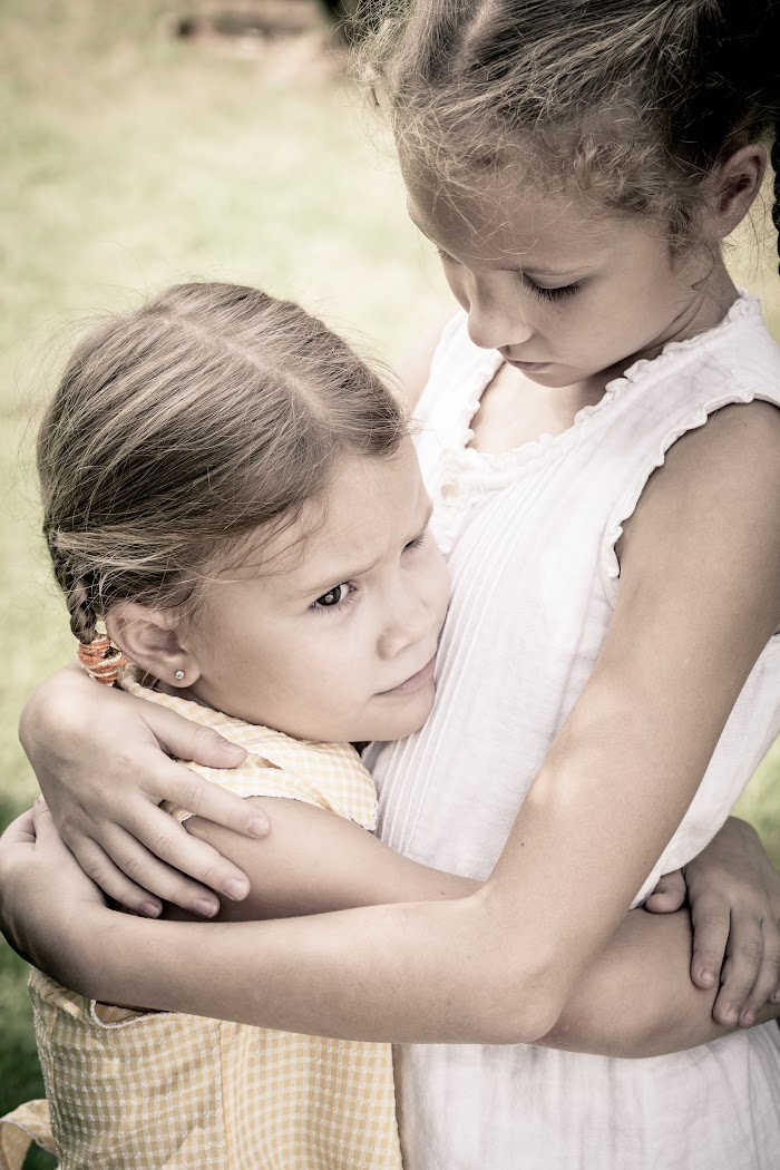 two girls, sad, hugging