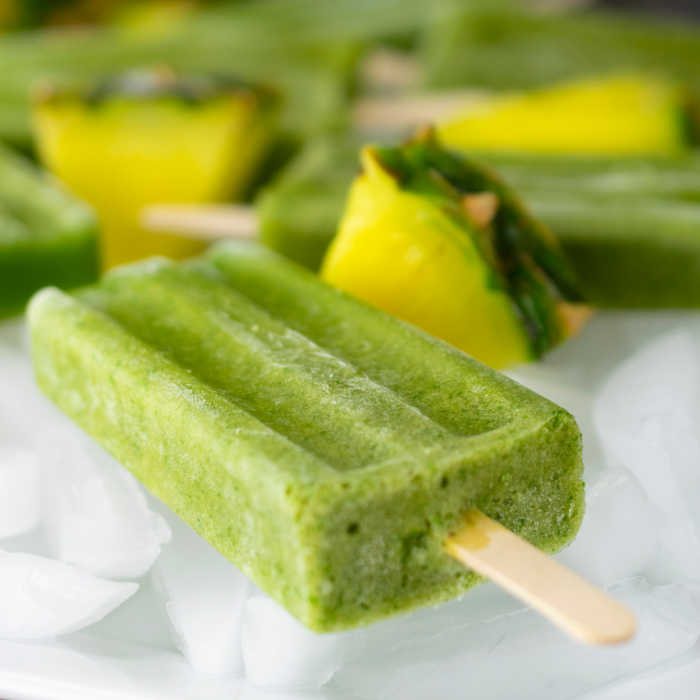 Green Popsicles for kids on ice with pineapple