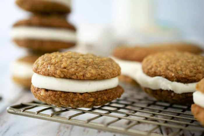 Oatmeal cookie sandwiches cooking on rack