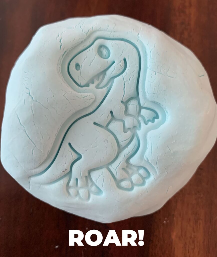 cloud dough stamped with dinosaur stamp
