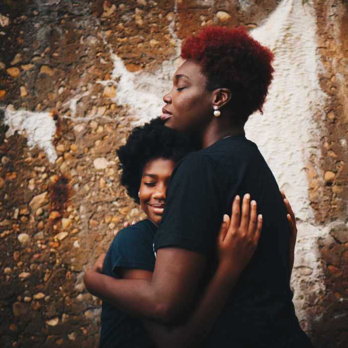 black mother and daughter in a loving hug