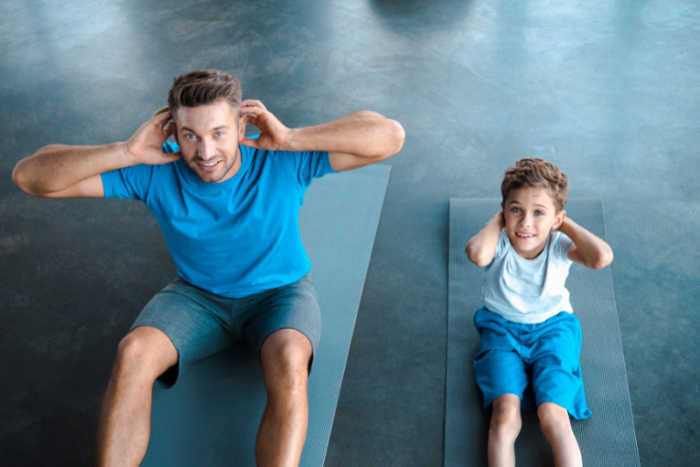 father son doing sit ups together