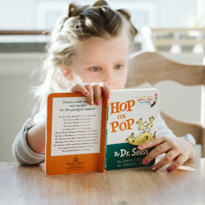 young girl reading dr seuss hop on pop