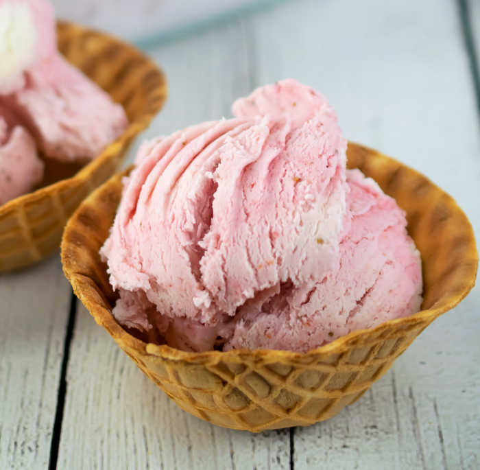 Homemade summer strawberry ice cream recipe in a waffle cup