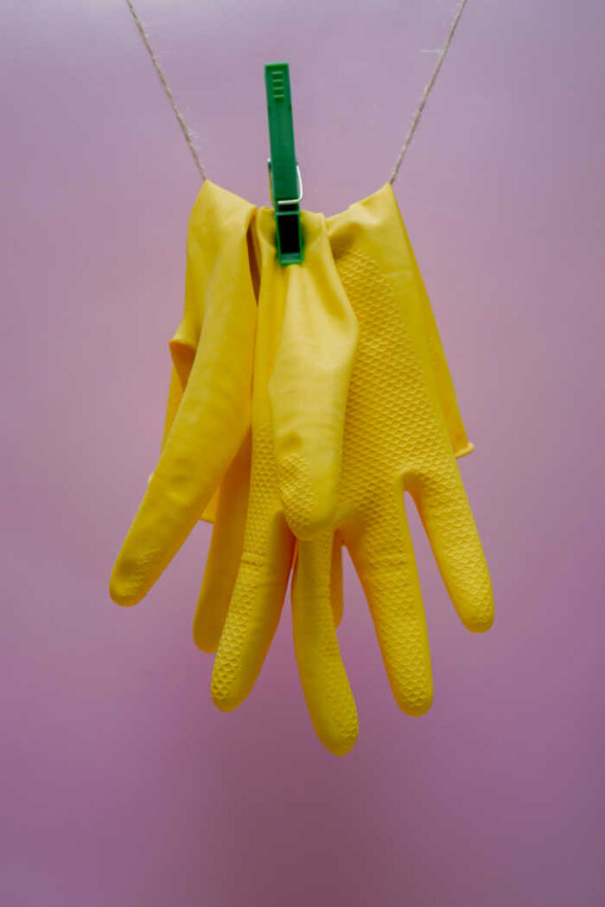 yellow cleaning gloves hanging to dry