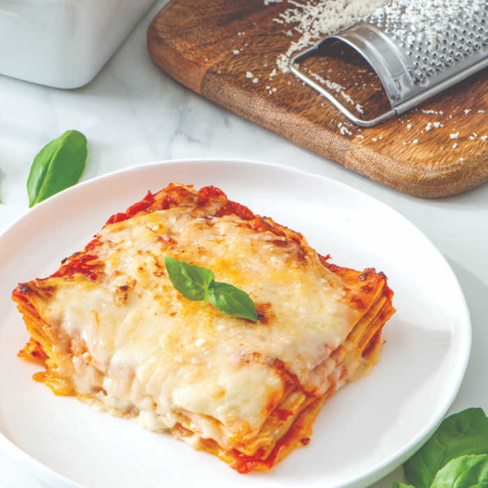 piece of lasagna with grated parmesan