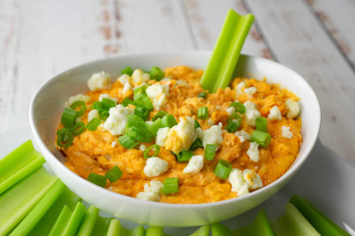 game day buffalo chicken dip with celery and blue cheese crumble - perfect for the big game