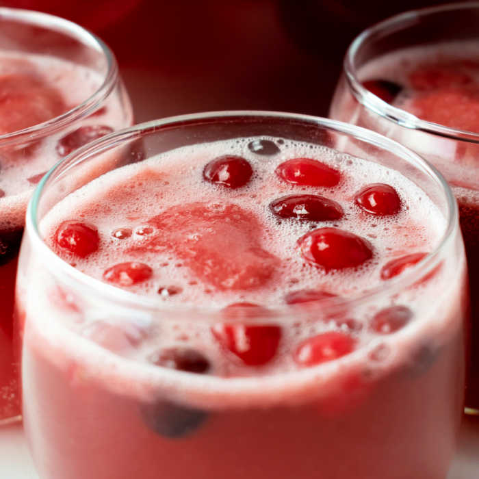 close up of cranberries floating in holiday punch