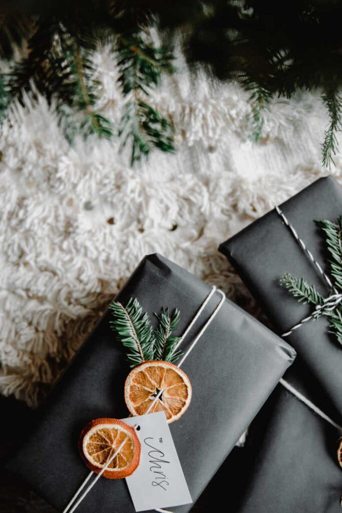 modern christmas wrapping with black paper, dried orange slices