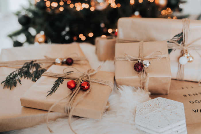 christmas presents wrapped in brown paper with christmas bells