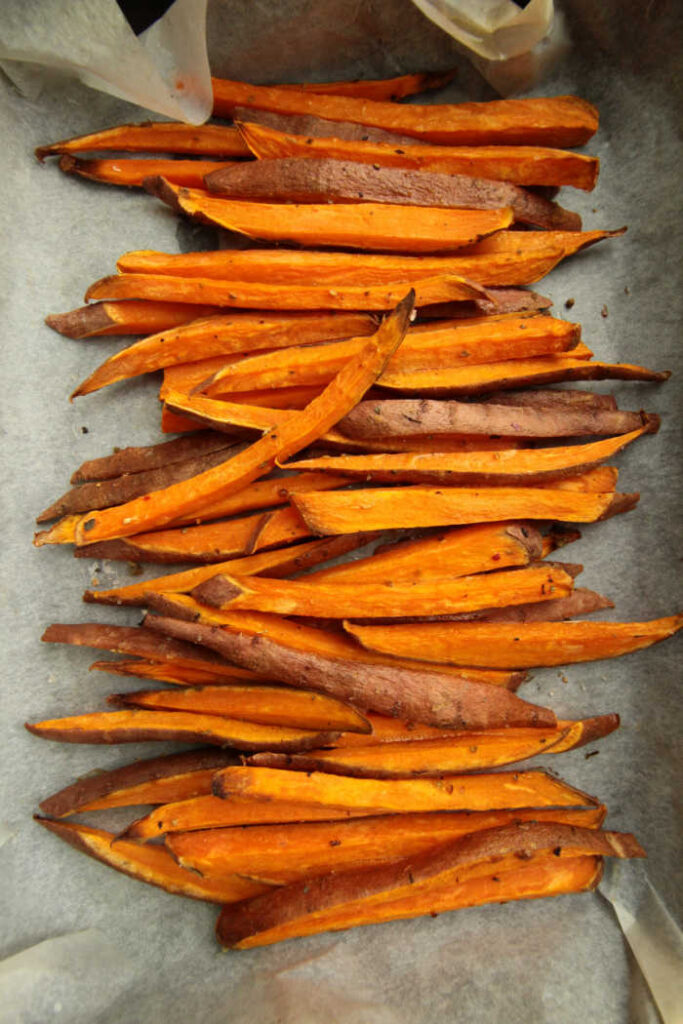 sweet potatoes - cut up in fries on parchment paper