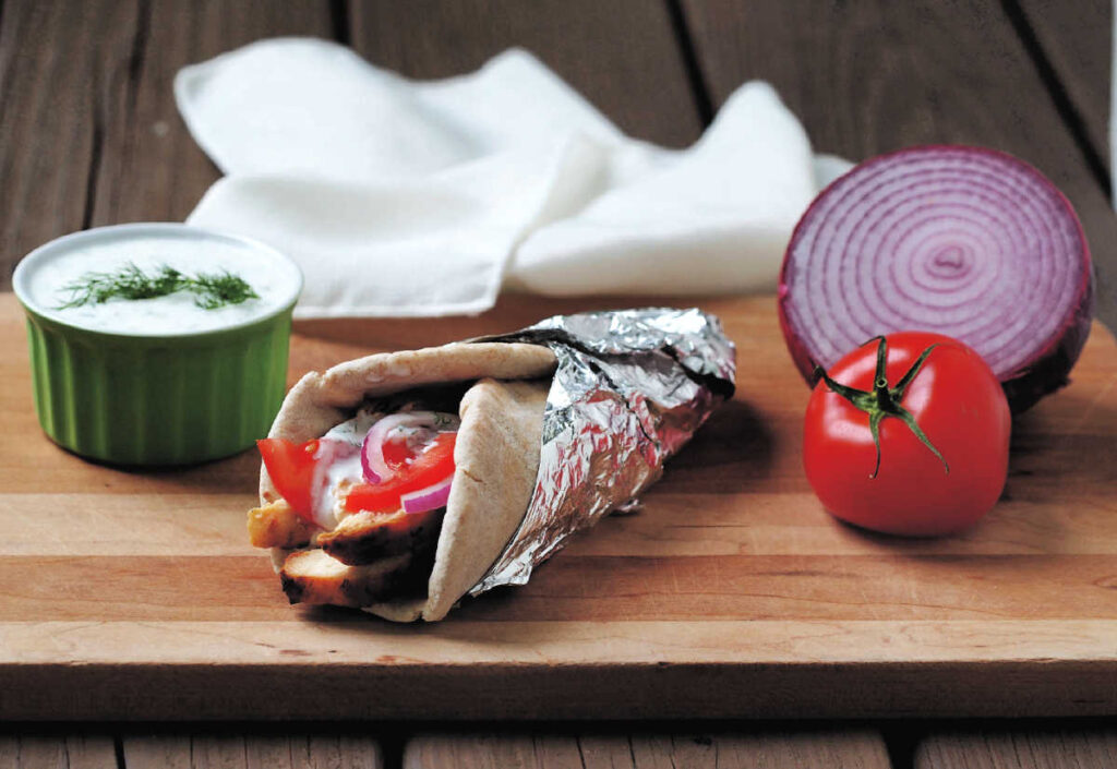 grilled chicken gyros with red onion, tomato and greek yogurt sauce