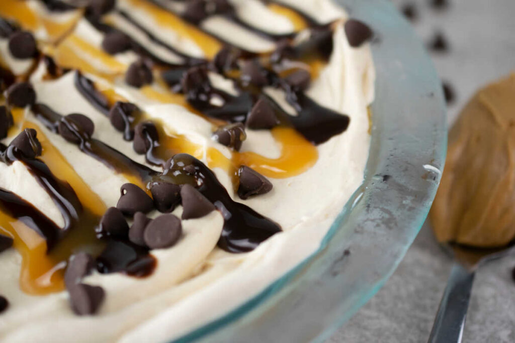 peanut butter pie drizzled with chocolate and caramel sauce