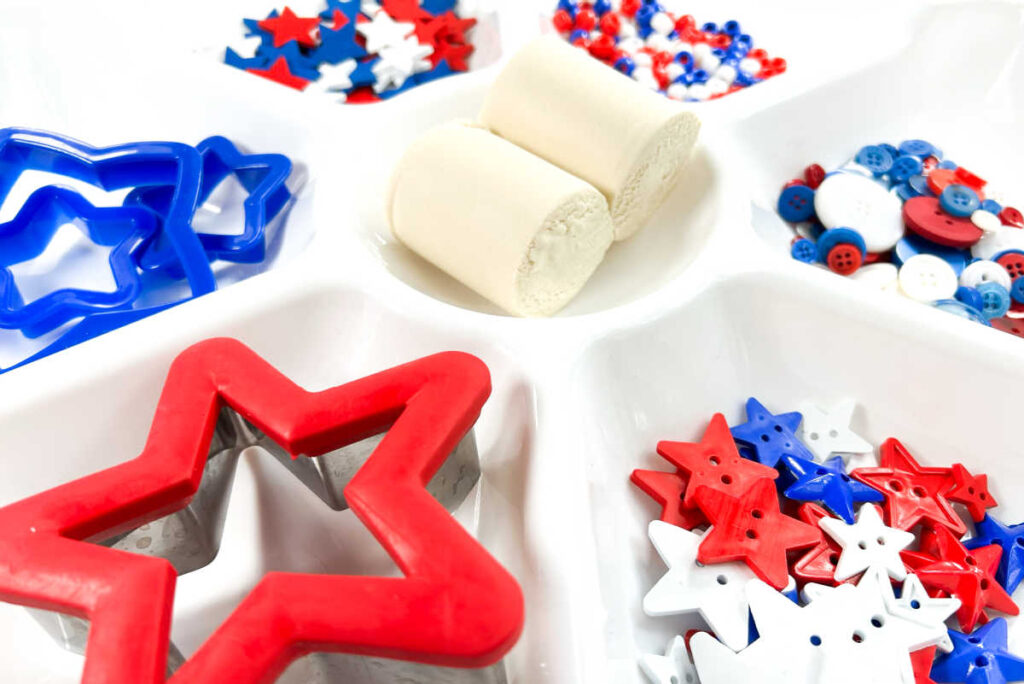 items set up in white tray ready for 4th of july invitation to play
