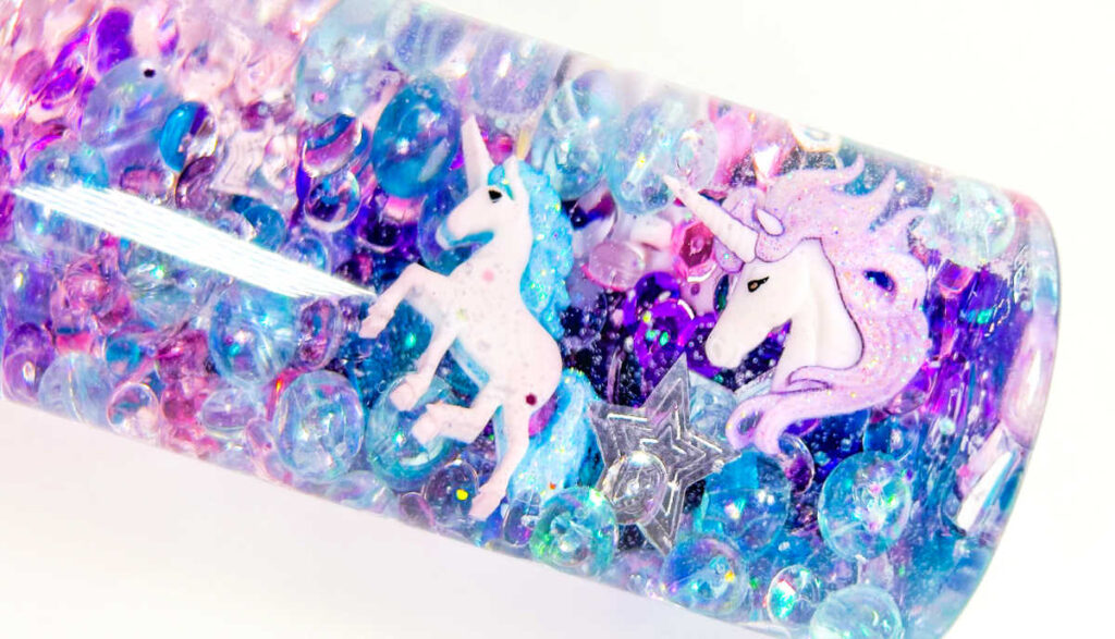 beautiful unicorn sensory bottle with clear, blue, pink and purple sequins and glitter