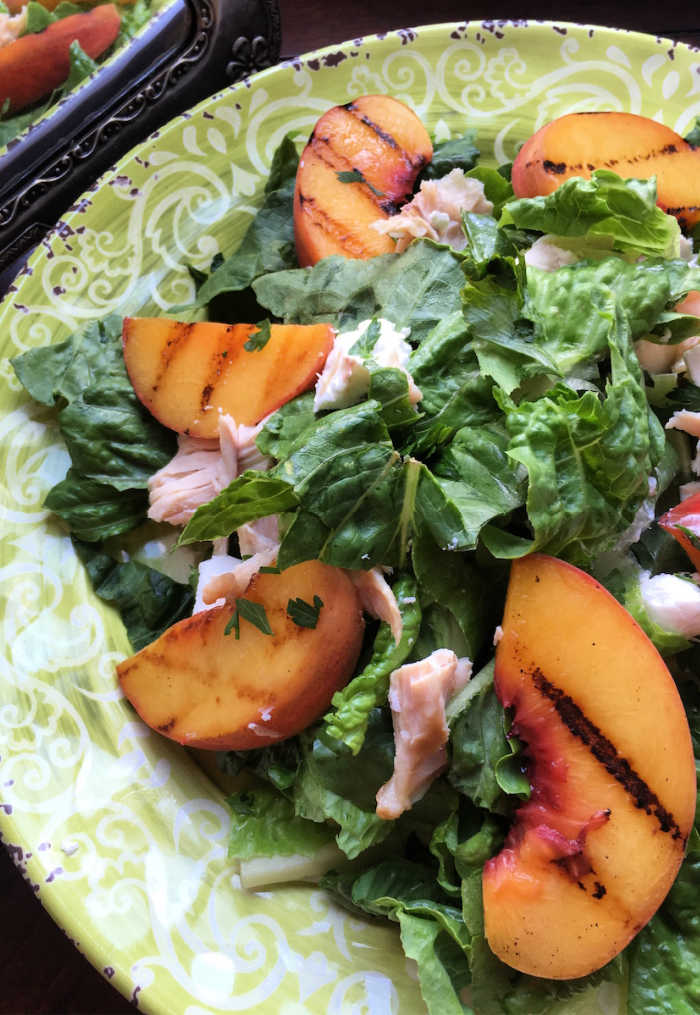 Grilled Peach Salad with Champagne vinaigrette is a sensational dish that combines the natural sweetness of grilled peaches with the delicate tang of a Champagne-infused dressing. There's nothing like perfectly light summer Salad Recipes!
This exquisite salad is a celebration of summer flavors, featuring juicy grilled peaches nestled on a bed of crisp greens, accompanied by an array of complementary ingredients.