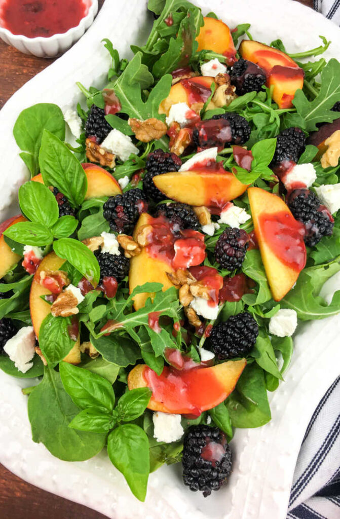 Experience the essence of summer with this exquisite Blackberry Peach Salad with a luscious Blackberry-Basil Vinaigrette. 
This vibrant salad combines the juicy sweetness of ripe peaches with the tartness of succulent blackberries, creating a delightful balance of flavors.