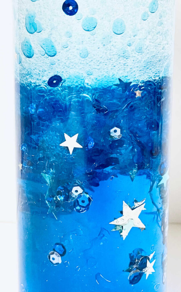 Blue calming sensory bottle with stars and sequins