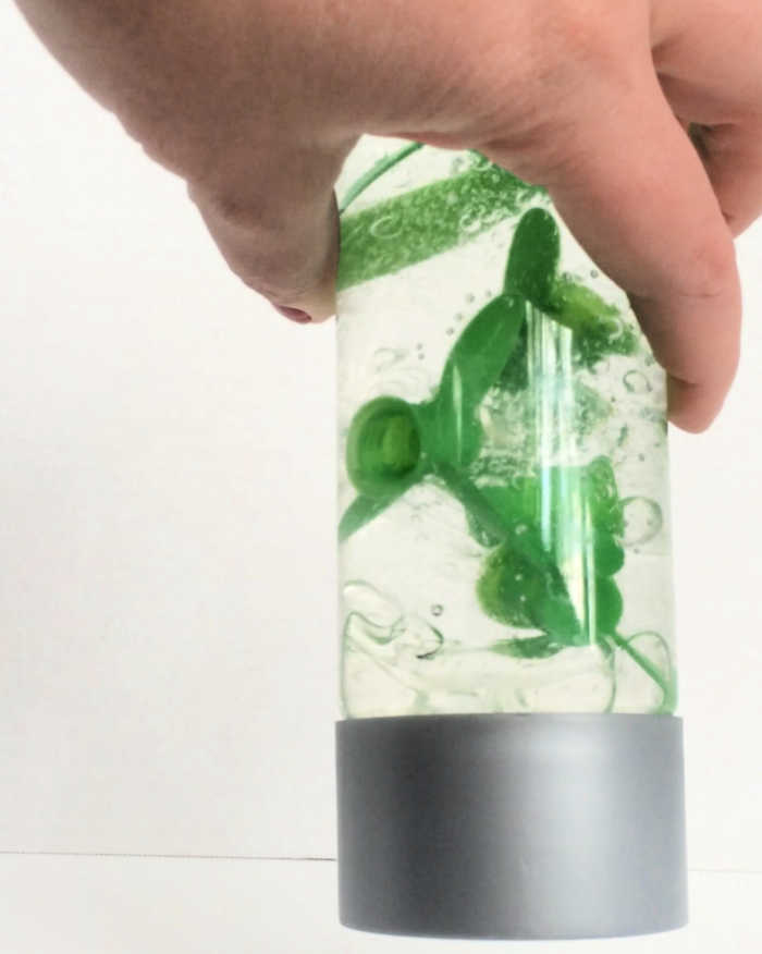recycled sensory bottle with green gogo applesauce tops