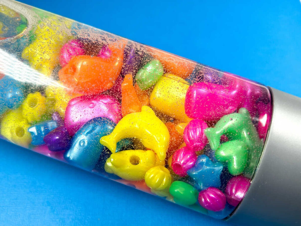 close up of bright colorful ocean animals in a sensory bottle surrounded by bubbles