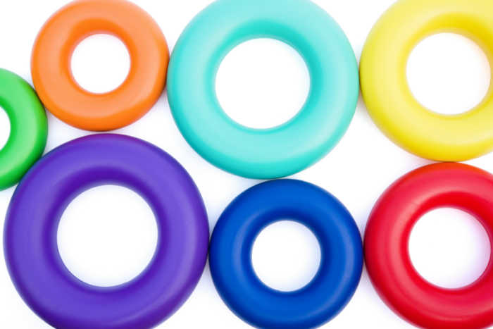 plastic stacking rings laying down on white background