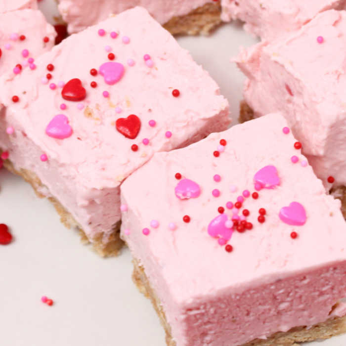 strawberry cheesecake bars topped with sprinkles