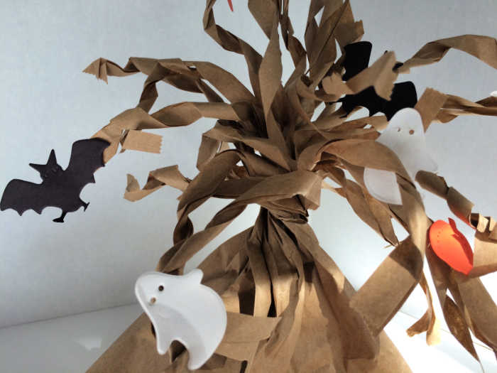 close up of halloween craft spooky paper bag tree activity for kids