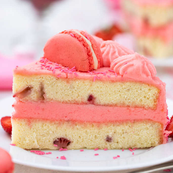 slice of pink cake topped with macaroon