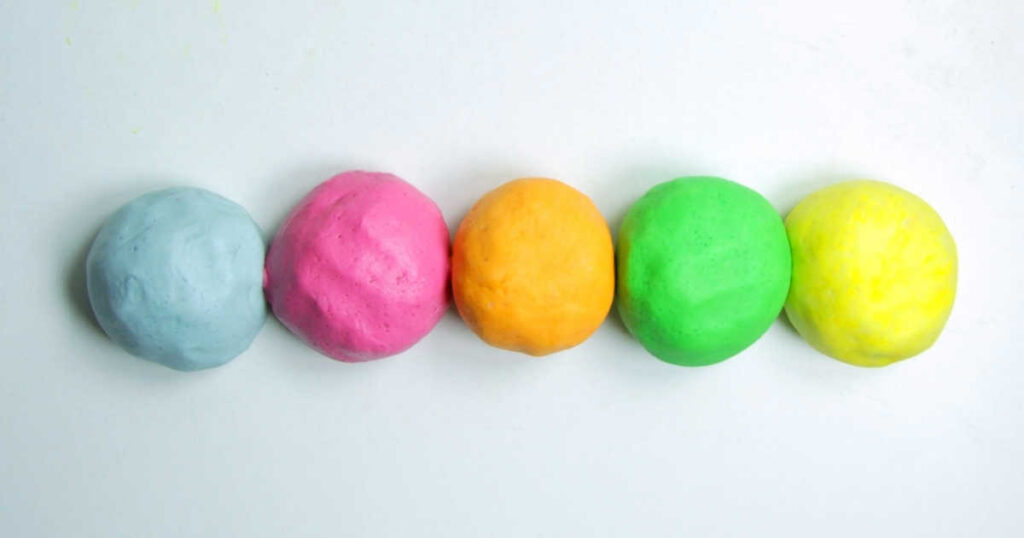 row of 5 balls of colored homemade play dough