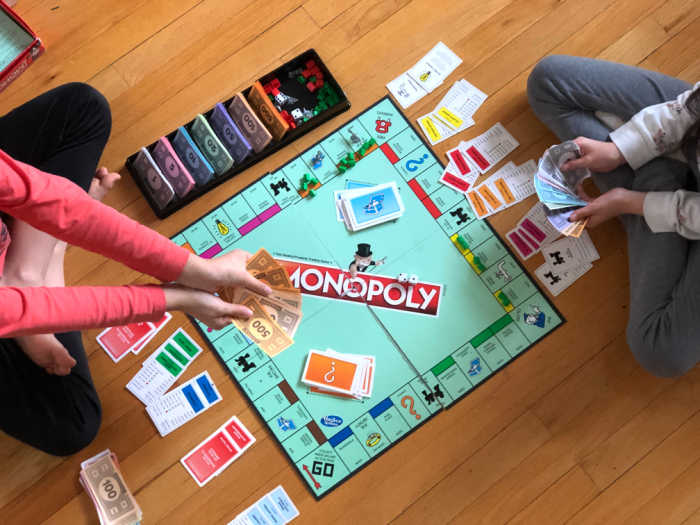 kids playing monopoly board game