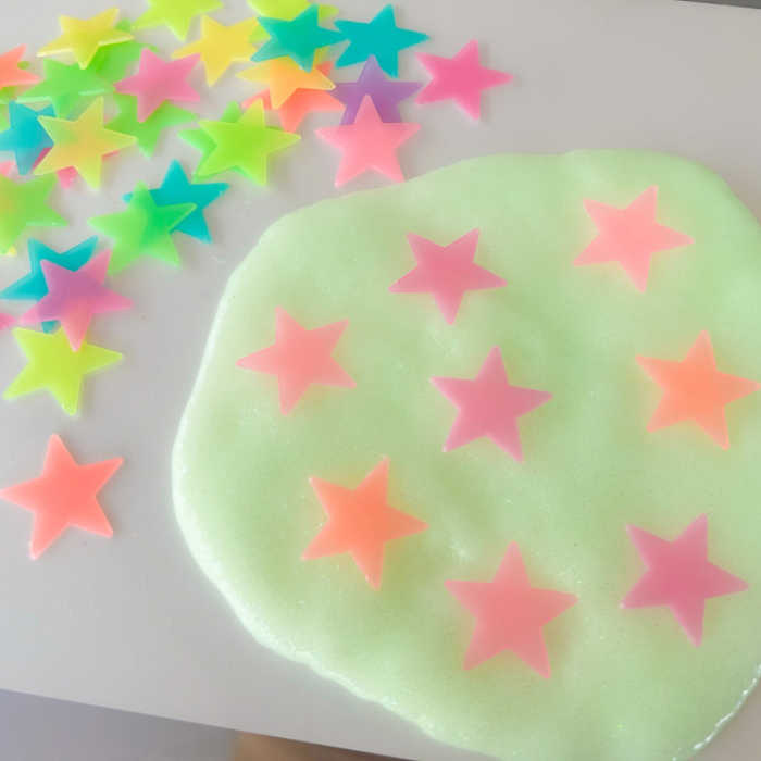 glow in the dark glowing slime in natural light with colorful glow in the dark stars